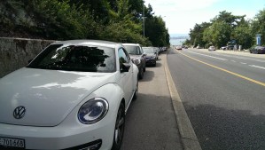 Cars using half the bike path as a parking lot